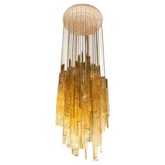 a large chandelier made out of glass tubes and gold lusted metal rods