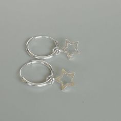 ** Please go through all the pictures i have posted for a listing to get an exact idea of the actual size of the item.A PAIR of sterling silver hoops. Comes with a detachable tiny and delicate star charm.The charm is multipurpose and can be used with a neck or bracelet chain too.Dimension: Hoop- 12 x 1.2 mm   Charm- 6 x 6 mm  Weight: 0.97 gmPrice listed is for a PAIR of hoops.These earrings are made of 925 hypoallergenic sterling silver and comes with a 925 stamp.Can be packaged in a gift box. I Silver Dangle Hoop Earrings With Star Charm, Minimalist Silver Star Hoop Earrings, Sterling Silver Star Charm Huggie Earrings, Sterling Silver Star Charm Cartilage Earrings, Silver Star Huggie Earrings For Everyday, Silver Star-shaped Minimalist Huggie Earrings, Silver Dainty Star Charm Earrings, Silver Star-shaped Hoop Earrings For Everyday, Minimalist Star-shaped Sterling Silver Huggie Earrings