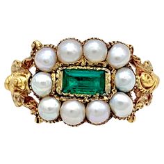 This bright Georgian was ceated in the 1820's. The ring is set with ten natural white oriental half pearls. The pearls are set in a grooved setting that follows the outline of the pearls. The center of the ring head is decorated with a rectangular table cut emerald. The emerald is set in a finely engraved closed gold mount within an outer gold frame. The pierced ring shoulders are executed in high relief and decorated all over with scroll work. Regency Engagement Ring, Georgian Ring, Pearl Rings Vintage, George Iv, Diamond Pendants Designs, Antique Jewelry Rings, Shiny Objects, Punk Vintage, Ring Emerald