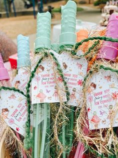 there are many straw wrapped items in the basket with some tags on them and one is tied to it