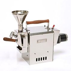 a machine that is sitting on top of a white surface with a wooden handle in the middle