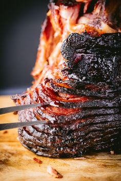 the cover of smoked spiral ham on a cutting board with a knife sticking out of it