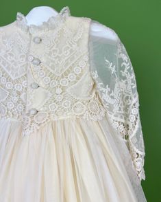 A unique and exquisite full vintage lace gown. Beautiful hand-embroidered lace in ivory. It has three clip-on on the back for closure. Does not include bonnet Made in Spain 100% polyester Dry Cleaning Final Sale, no exchanges nor returns are available Cream Baptism Dress With Lace Bodice For Formal Occasions, Formal Cream Baptism Dress With Lace Bodice, Cream Long Sleeve Dress For Ceremony, Classic Lace Dresses With Lace Bodice, Elegant White Lace Dress For Vintage Events, Cream Long Sleeve Ceremony Dress, White Lace Bodice Dress For Vintage Events, Fitted Cream Lace Dress For Ceremony, Cream Fitted Lace Dress For Ceremony