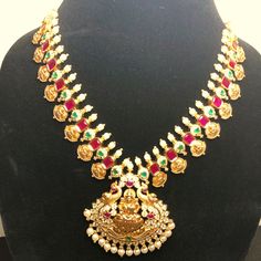 This Is A Gold Plated Necklace With Matte Finished. It Comes With Pearls And Red Stones. The Design Includes Laxmi Devi Who Is Considered Goddess For Money. And Is Considered As A Goddess For Luck. Indian Jewelry, Bollywood Style. Pearl Necklace With 17 Jewels For Weddings And Festivals, Temple Jewelry Style Necklaces With Jewels For Weddings, Temple Jewelry Style Necklaces For Wedding, Temple Jewelry Style Wedding Necklaces, Silver Temple Necklace With Jewels For Wedding, Silver Jeweled Temple Necklace For Wedding, Festive Wedding Necklace With Jewels, Temple Necklace With Jewels For Wedding Festivals, Jeweled Temple Necklace For Weddings