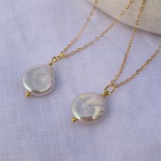 Natural Freshwater Baroque Coin pendant comes on a 14 K gold-filled chain. It is a perfect statement piece and a great necklace to style solo or layered with other necklaces. Please note: each pearl is unique, no two are the same ,  but they all are beautiful. Details: - Baroque coin white pearl size 13-14 mm, very good luster  - Pearl is set on a sterling silver gold plated headpin. - 14 K gold-filled chain with a lobster clasp. - Chain's length : 35 cm ( 14 inch), 40 cm ( 16 inch), 45 cm ( 18 inch), 50 cm ( 20 inch) ► PACKAGING / GIFT BOX All jewellery is carefully packed in our signature Sparklez jewellery box. To reduce waste, we often put an order with multiple pieces in one or two gift boxes. If you would like your order to be boxed separately or if only part of your order is intende Gold Pearl Drop Pendant Bridal Necklace, Gold Pearl Bridal Necklace With Delicate Chain, Gold Plated Pearl Pendant Necklace For Wedding, Gold Dangle Charm Necklace With Pearl Drop, Gold Drop Necklace With Pearl Charm For Wedding, Teardrop Gold Plated Necklace For Wedding, Gold Plated Teardrop Necklace For Wedding, Dainty Gold Bridal Necklace With Pearl Drop, Gold Necklace With Adjustable Chain For Bridesmaid Gift