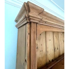 an old wooden bed frame with the headboard and foot board up against the wall