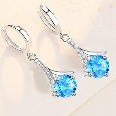 "925 Sterling Silver Water Drop Blue Crystal Zircon Earrings For Woman, J852 Metal: 925 Sterling Silver Stone: Cubic Zirconia 100 % Lead And Nickel Free 100 % Hypoallergenic Will Not Tarnish Or Fade Perfect For Gift, Holiday, Christmas, Birthday, Vacation, Mother's Day, Valentine's Day, Wedding, Engagement , Bridal, Promise, Anniversary, Party Item Code: E019 Thank You For Shopping With Us!""" Elegant Blue Round Cut Earrings, Blue Cubic Zirconia Earrings With Prong Setting, Blue Gemstone Earrings With Cubic Zirconia, Blue Cubic Zirconia Gemstone Earrings, Blue Gemstone Earrings In Cubic Zirconia, Blue Topaz Blue Earrings, Blue Drop Earrings With Prong Setting, Classic Light Blue Sterling Silver Jewelry, Blue Diamond Round Cut Earrings