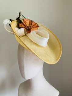 Yellow This smart primrose yellow sinamay disc hat features ivory silk abaca trim and ivory vintage veiling, accented with a copper-coloured vintage poppy flower and vintage olive-coloured ribbon. The hat is fitted with a headband, and is light and easy to wear. This piece is suited to a number of occasions, particularly weddings, Royal Ascot and other race events, and garden parties. The brim is wide enough to give a little bit of drama, but not so wide that you'll feel conspicuous. This shape relies more on a little bit of height rather than width - but not so high that you'll have trouble in doorways. The shape is hand-sculpted to compliment the face, and the hat is worn at an angle designed to flatter. Light and feminine, without being fussy and overdone. Colours not quite right? Conta Gold Summer Fascinator For Garden Party, Gold Fascinator For Summer Garden Party, Gold Fascinator For Garden Party, Elegant Brown Hat For Garden Party, Gold Fascinator For Kentucky Derby Garden Party, Adjustable Gold Mini Hats For Garden Party, Fitted Top Hat For Spring Vintage Events, Sinamay Fascinator For Garden Party, Summer Adjustable Fascinator For Vintage Events