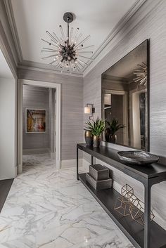 an elegant entry way with marble floors and walls