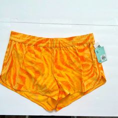 These Shorts Highlight A Standard Fit With An Adjustable Waistband For A Customized Fit And Slash Side Pockets. Brushed Back Finish Provides Breathability And Flexibility. The Fabrics Contour Curves To Promotes A Relax Feel. Orange Summer Shorts For Poolside, Orange Short Swimwear For Spring, Orange Beach Shorts With Elastic Waistband, Orange Stretch Shorts For The Beach, Orange Stretch Shorts For Beach, Sporty Orange Shorts For Vacation, Casual Orange Swimming Shorts, Casual Orange Bottoms For Poolside, Casual Orange Short Length Swimwear