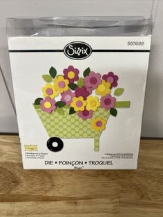 a box with some flowers in it on a table