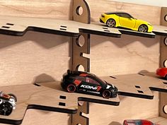 toy cars are lined up on wooden shelves