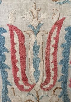 an old rug with red, white and blue designs on it