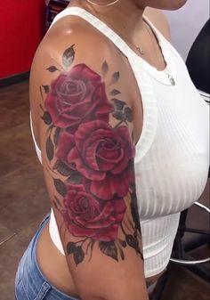 a woman with a rose tattoo on her arm