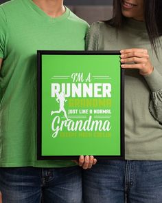 a man and woman holding up a green framed sign that says, i'm a runner grandma just like a normal grandma