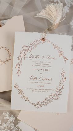 the wedding stationery is laid out on top of each other, including two cards