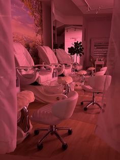 a room filled with lots of white chairs sitting next to each other on top of hard wood flooring