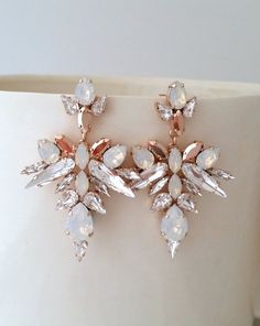 ✤ I can make these earrings with other colors to match your wedding party scheme (or any other occasion). Please just contact me.✤ Matching bracelet here:https://etsy.me/2rKFgE3✤ Matching hair comb here:https://etsy.me/2BJdLwi✤ Matching necklace here:https://etsy.me/2OWrTK7https://etsy.me/2rK9F5s✤ Available in other metal finishes at the drop-down menu.✤ Made with CRYSTALLIZED™ - Swarovski crystals.✤ Stud/post Earrings. ✤ Size approx - 6.7 x 4.5 cm  at the widest points ✤ Light weight.✤ Colors: Jeweled Dangle Earrings For Wedding, Wedding Dangle Earrings With Jewels, Dazzling White Sparkling Chandelier Earrings, Glamorous White Drop Chandelier Earrings, Elegant Crystal Jeweled Earrings For Wedding, Elegant Wedding Crystal Earrings, Glamorous White Chandelier Earrings With Sparkling Stones, Exquisite White Bridal Earrings For Party, White Sparkling Glamorous Bridal Earrings