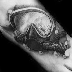 a black and white photo of a man's arm with a diving mask on it