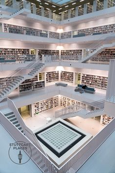 an aerial view of a library with many bookshelves and stairs leading up to the second floor