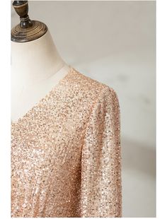 a dress on a mannequin with gold sequins