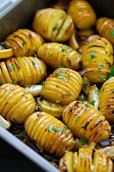 cooked potatoes in a pan with herbs and seasoning on the side, ready to be eaten