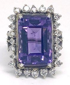 "Lady's vintage amethyst, diamond and white gold ring. Beautiful ring with what appears to be an emerald cut amethyst weighing approximately 5.25 ct. set in the center of a diamond halo with the round cut diamonds weighing approximately .71 ct. total weight. This piece weighs approximately 9.5 grams, is stamped \"18K\", and the ring size is approximately 6.  It is in excellent condition and would make a beautiful addition to your vintage jewelry collection." Etsy Gold Ring, Amethyst Gem, White Gold Ring, Beautiful Ring, Diamond Halo, Round Cut Diamond, Halo Diamond, White Gold Rings, Emerald Cut