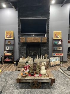 a living room filled with furniture and a flat screen tv mounted on the wall above a fire place