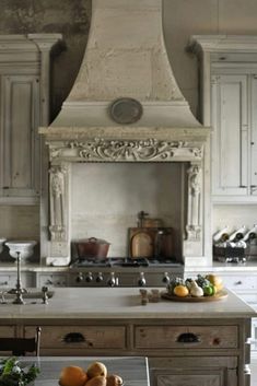 a kitchen with an oven, stove and fruit on the counter top in front of it