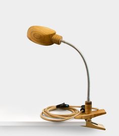 a wooden desk lamp with a cord attached to it