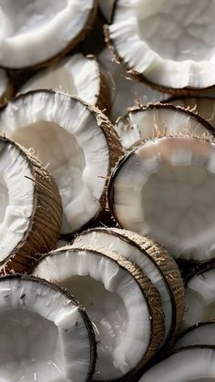 coconuts are stacked on top of each other in the middle of a pile, ready to be eaten