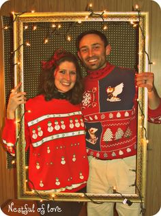 a man and woman dressed in ugly ugly sweaters pose for a photo with christmas lights around them