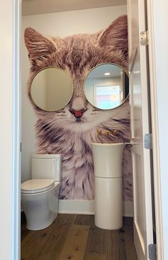 a cat with large round glasses on it's face is seen through the door