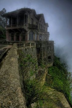 an old house on the edge of a cliff