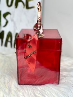 Level up your accessory collection with this unique acrylic handbag! Featuring gold hardware and a detachable self-wrap scarf, it is a must-have! Acrylic box handbagGold hardwareDetachable self-wrap scarf Designer Red Rectangular Box Bag, Designer Red Square Box Bag, Designer Square Box Bag For Gifts, Designer Red Box Bag For Gift, Trendy Top Handle Box Bag Gift, Red Rectangular Box Bag For Formal Occasions, Red Rectangular Box Bag, Chic Red Rectangular Box Bag, Trendy Rectangular Case Box Bag As Gift