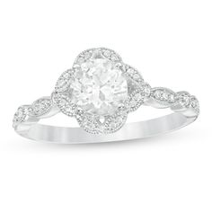 Display your romantic style with this beautiful vintage-inspired ring. Created in cool 10K white gold, this Art Deco look features a 6.0mm lab-created shimmering white sapphire wrapped in a frame of marquise shapes, each adorned with diamonds and intricate milgrain borders. Along the milgrain-lined shank, bezel-set diamonds alternate with diamond-lined marquise shapes. Radiant with 1/8 ct. t.w. of diamonds and a bright polished shine, this ring is a keepsake in the making. Classic Wedding Halo Ring With Diamond Cut, Classic Wedding Halo Ring With Diamond Accents, Elegant White Filigree Ring With Brilliant Cut, Elegant White Filigree Ring With Diamond Cut, Vintage White Gold Rings With Halo Design, Elegant White Cluster Ring With Halo Design, Vintage White Gold Ring With Halo Design, Classic White Filigree Ring With Brilliant Cut, Classic White Cluster Ring With Halo Design