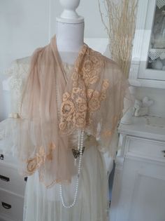 **A dream of tulle, pearls and fine embroidery** Here I have an enchanting apricot/beige scarf made of fine soft tulle for you with a delicate embroidered flower motif and pearl decoration. The tulle is beige and the embroidery appliqués are a bit apricot, they harmonize wonderfully together. It was processed to a very high standard, i.e. every single bead was sewn on and the embroidery was also done by hand. Thus, it is reminiscent of the Edwardian era in its noblest time, the Titanic era. Ther Elegant Beige Shawl For Spring, Elegant Lace Shawl, Embroidered Beige Shawl For Wedding, Feminine Cream Lace For Wedding, Elegant Embroidered Tulle Lace, Beige Lace For Spring Wedding, Embroidered Cream Shawl For Wedding, Spring Wedding Beige Lace, Bohemian Beige Shawl For Wedding