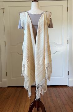 Elevate your outfit with this open front, Rebozo, fringed vest!! perfect for all occasions. Wear with any top or dress and any sleeve length.  Would be stunning over a bathing suit while vacationing or at home at the pool. let your imagination run wild to update your wardrobe.  Mexican Rebozo, shawl was woven on a traditional a pedal loom with 100 % cotton and silk trades in the state of Oaxaca Mexico.  Measures approximately: 98" Length (including Fringes) x 26" Width PC # B-755 PLEASE NOTE: Th Fringed Shawl For Summer Festivals, Bohemian Beige Shawl With Fringe, Beige Bohemian Shawl With Fringe, Summer Shawl With Fringe, Summer Fringe Shawl, Bohemian Fringe Vest For Festivals, Bohemian Fringe Shawl For Spring, Bohemian Fringe Vest For Spring, Bohemian Fringe Vest