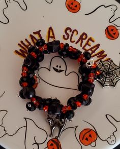 a white plate topped with a halloween bracelet