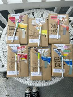 several brown notebooks with different types of pens and paper on them sitting on a white chair