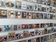 the wall is covered with many different sports cards