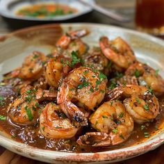 a white plate topped with cooked shrimp and gravy