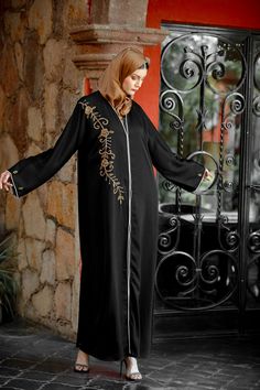 Premium Khaleeji Edition Open Abaya The Black Beaded Button Down Open Front Abaya is sophisticated and graceful! Featuring high quality nida fabric with perfectly placed beading on the chest and arms. You will be looking for an excuse to wear this beautiful abaya. Team it up with one of our dresses. 100% Nida Fabric Beaded Detailing Button Down Model is 5'5" and wearing size S Maternity Friendly Nursing Friendly Elegant Long Abaya With Dabka Work, Formal Abaya With Dabka Work For Eid, Formal Eid Abaya With Dabka Work, Formal Floor-length Embroidered Abaya, Elegant Long-sleeved Dabka Abaya, Elegant Long Sleeve Abaya With Dabka, Embellished Long Sleeve Thobe For Eid, Traditional Embellished Formal Abaya, Elegant Embroidered Formal Thobe