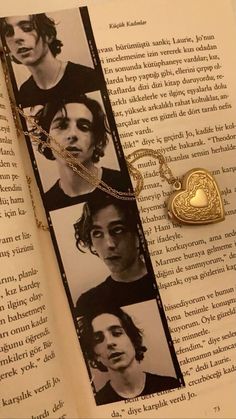 an open book with pictures of people on it and a gold heart charm hanging from the front