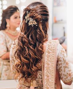 a woman is getting her hair done in front of a mirror and looking into the mirror