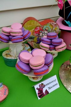 colorful macaroons and cupcakes are on display at a party or celebration