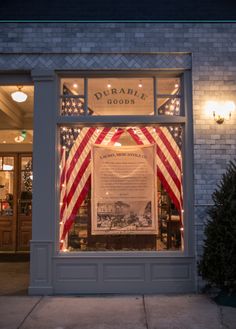 a store front with an american flag in the window