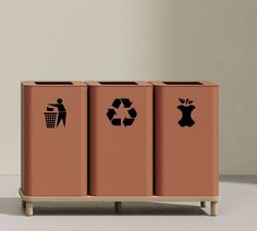 three recyclable trash cans with stickers on them