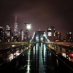 the city skyline is lit up at night