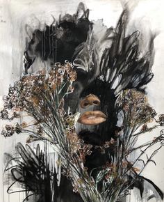 a painting with black and white flowers in front of a face on the side of a wall